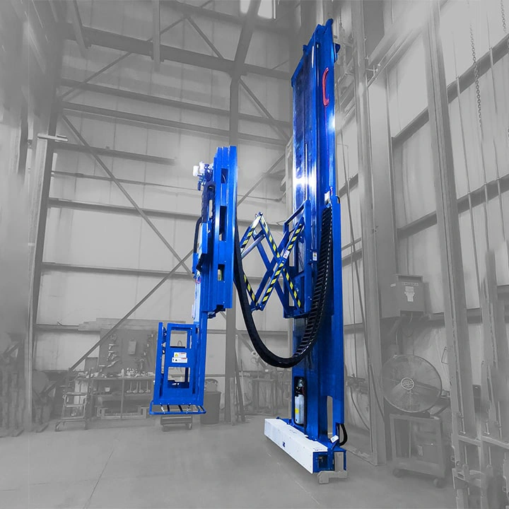 Blue paint booth man lift positioned inside a booth.