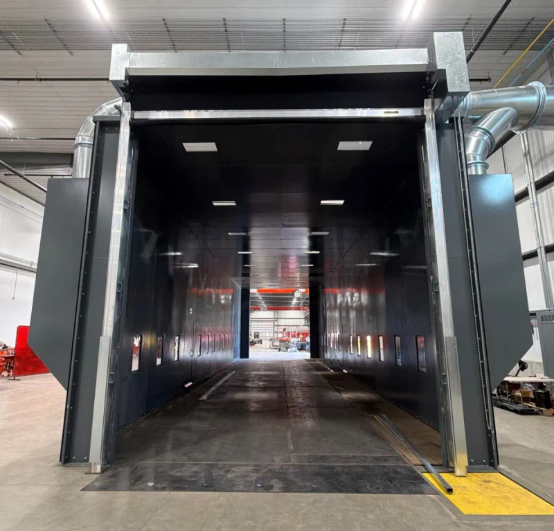 Interior of a blast booth with bright vertical lighting.