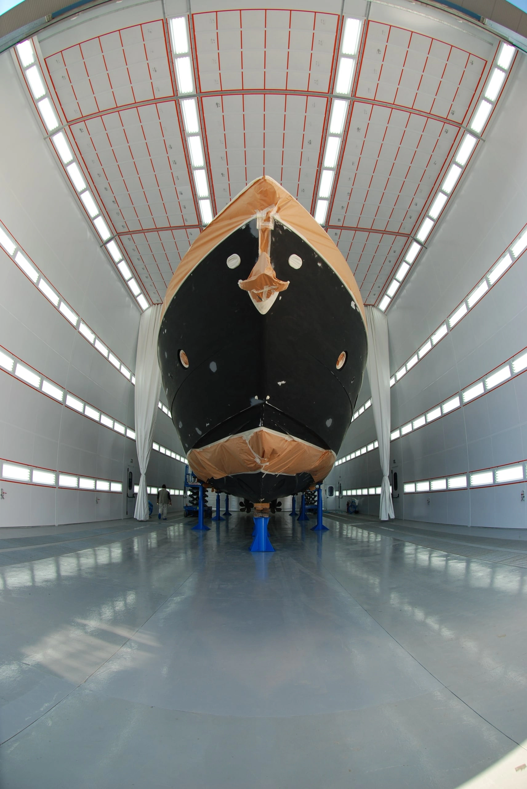 Ferretti yacht inside a marine paint booth.