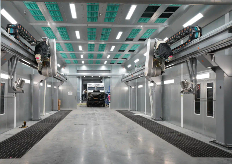 Enclosed industrial paint booth installed inside a production facility.