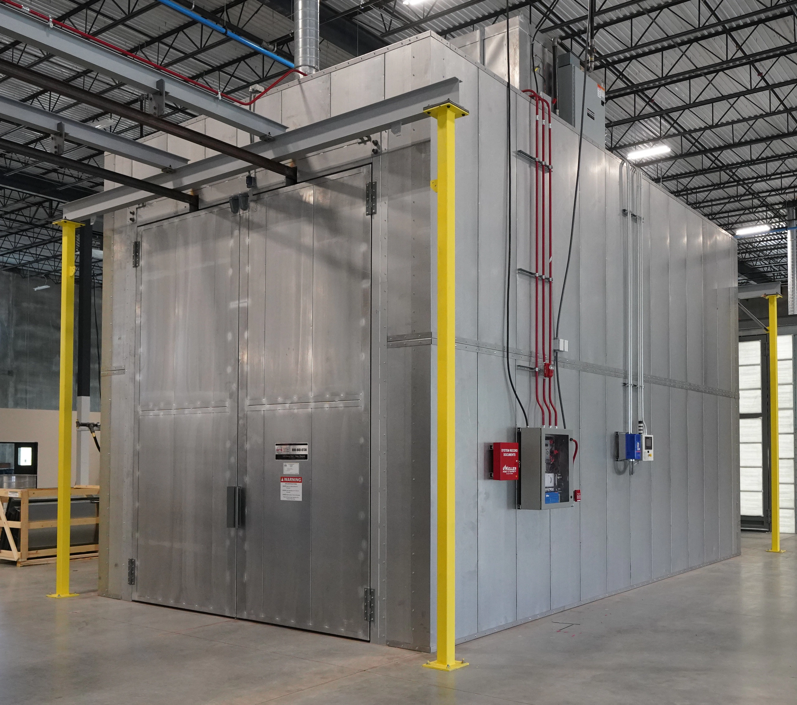 Powder coating oven with insulated panels and access doors.